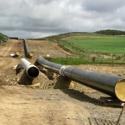 Pipeline on a hillside supported by timber